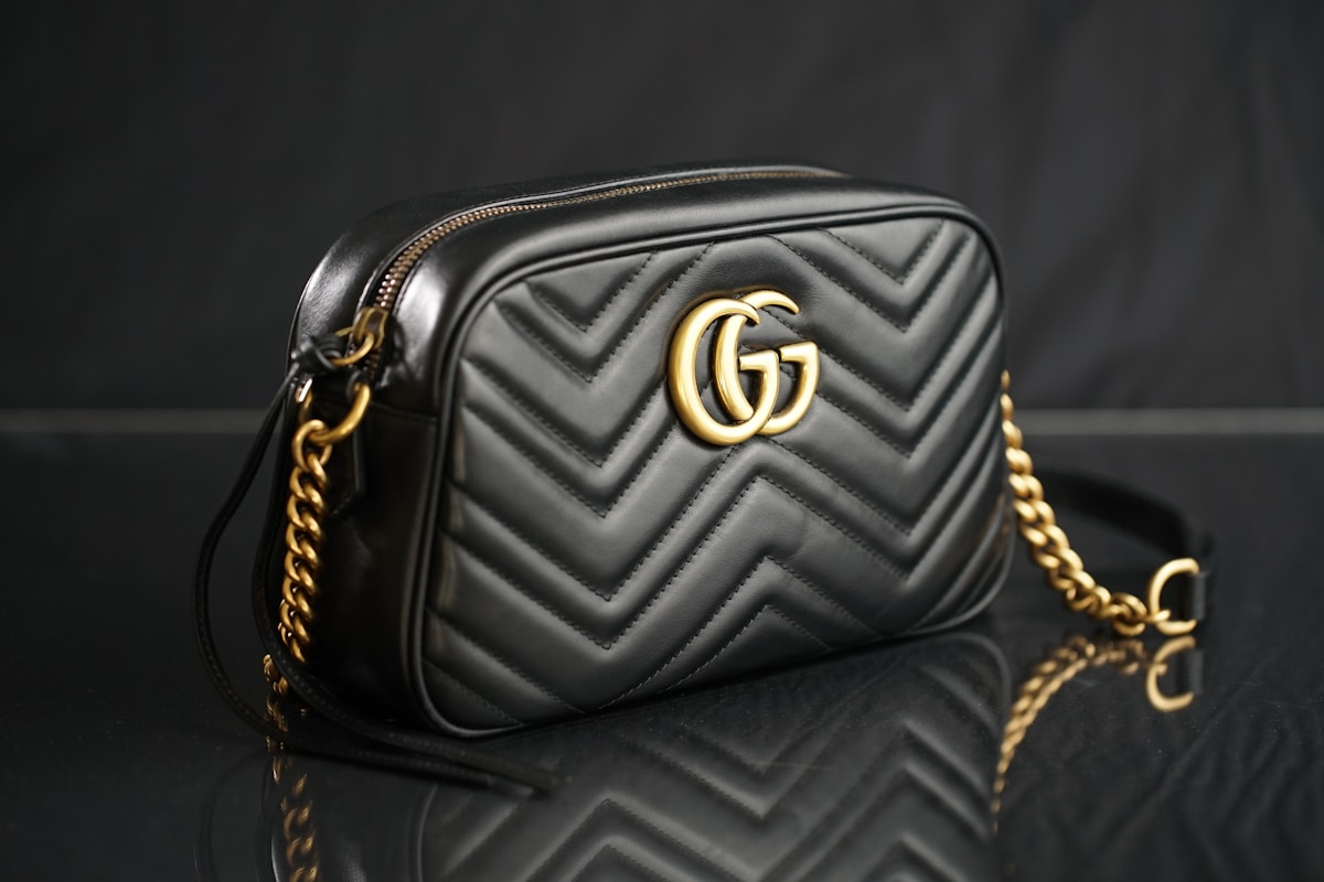 Leather crossbody bag on marble surface in warm light